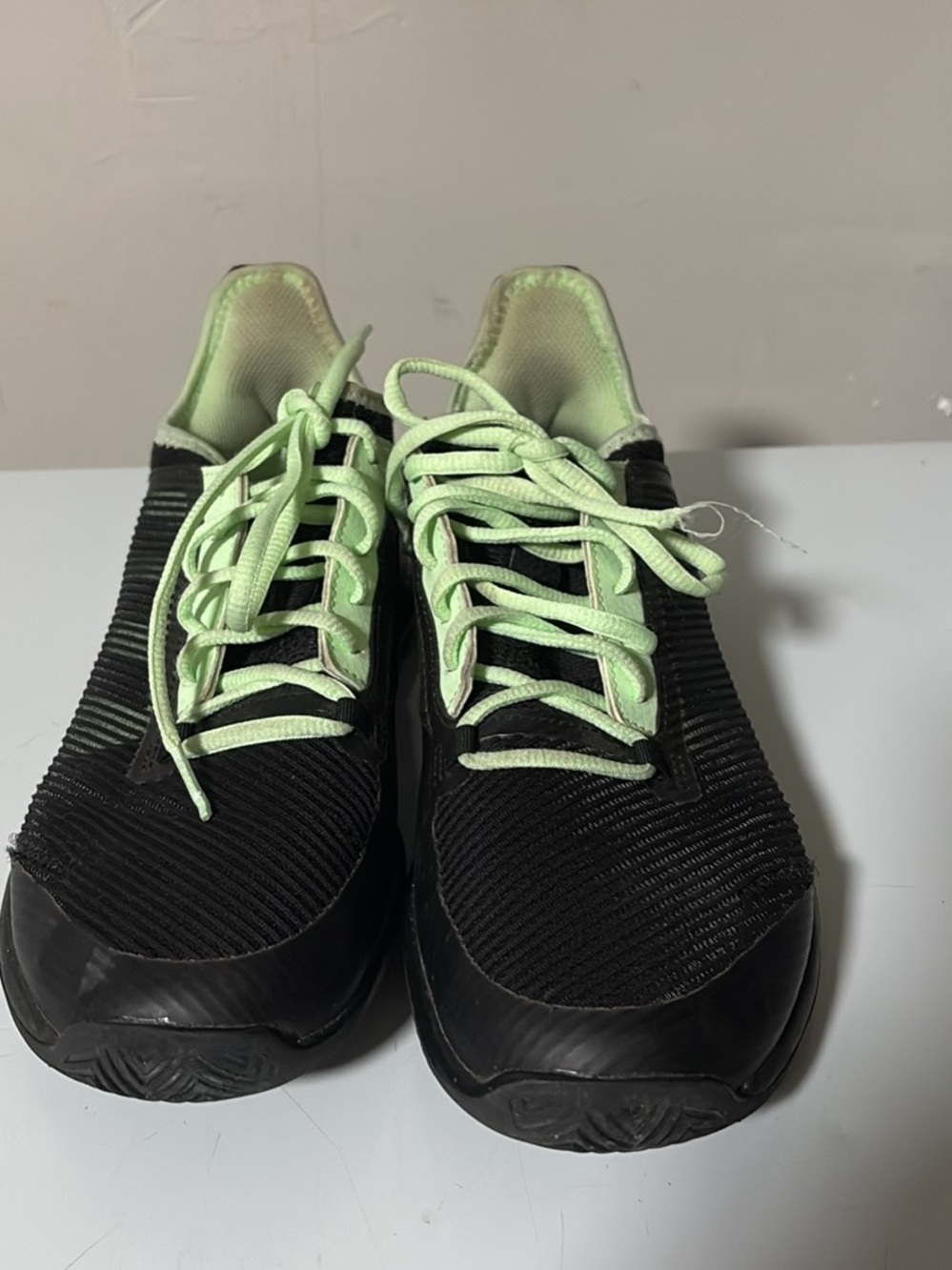 Adidas Bounce black and glow green athletic shoes.
